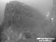 Accommodation front view. The picture demonstrates the ship's port list, and is typical of the wreck's condition with regards to marine growth and netting and fishing line caught on her.