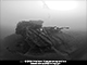 The stern has been blown off from the torpedo hit. Note the distorted plating in way of the starboard hull.